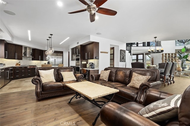 5390 Carlsbad Blvd, Carlsbad, CA 92008 - living room with a chandelier, a ceiling fan, and light wood finished floors
