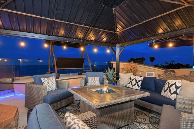 5390 Carlsbad Blvd, Carlsbad, CA 92008 - patio at twilight featuring an outdoor living space with a fire pit, a gazebo, and a patio
