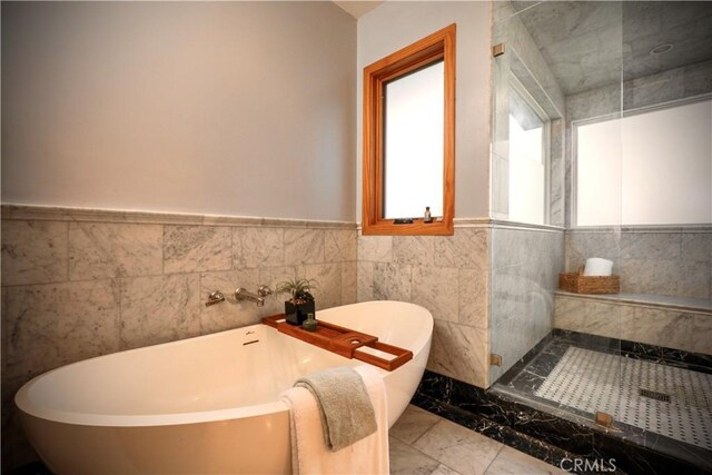 3700 Koster Ave, Sherman Oaks, CA 91423 - bathroom featuring marble finish floors, a soaking tub, tile walls, wainscoting, and an enclosed shower