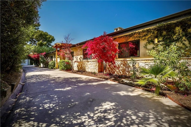 3700 Koster Ave, Sherman Oaks, CA 91423 - view of front of home with stucco siding, stone siding, and concrete driveway