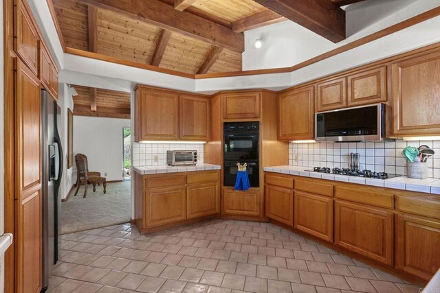 46920 Rainbow Canyon Rd, Temecula, CA 92592 - kitchen featuring wood ceiling, stainless steel microwave, gas stovetop, backsplash, and fridge with ice dispenser