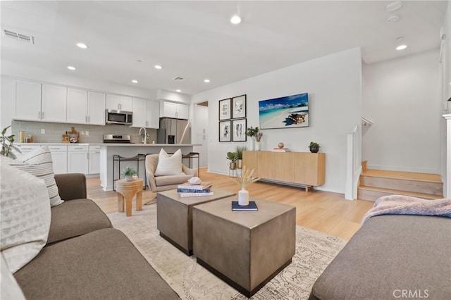 305 Blackrock, Lake Forest, CA 92610 - living room with light wood-style flooring, recessed lighting, and stairs