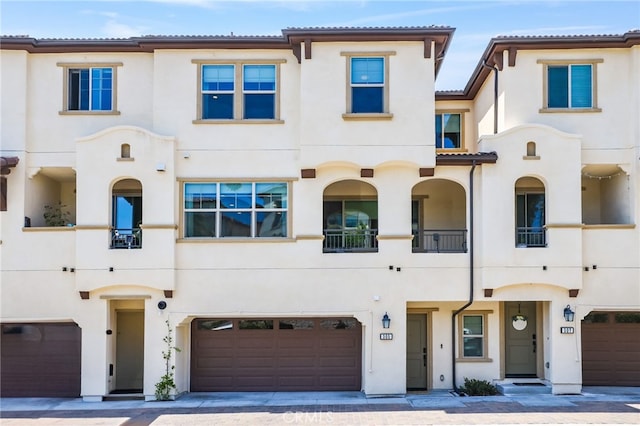 305 Blackrock, Lake Forest, CA 92610 - view of front of property featuring an attached garage, stucco siding, driveway, and a balcony