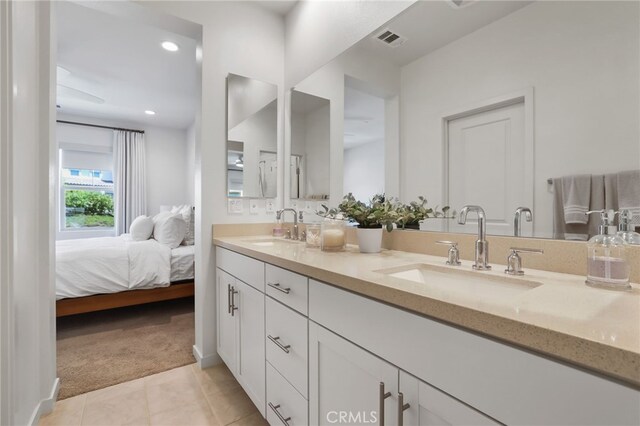 305 Blackrock, Lake Forest, CA 92610 - ensuite bathroom with double vanity, tile patterned floors, and recessed lighting