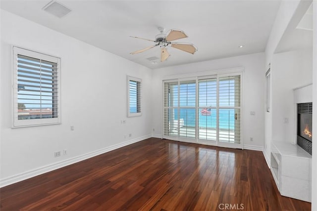 2016 Calle De Los Alamos, San Clemente, CA 92672 - unfurnished living room featuring dark wood-style flooring, a fireplace, ceiling fan, and heating unit