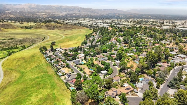 8601 Rudnick Ave, West Hills, CA 91304 - aerial overview of property's location featuring mountains, nearby suburban area, and a golf course
