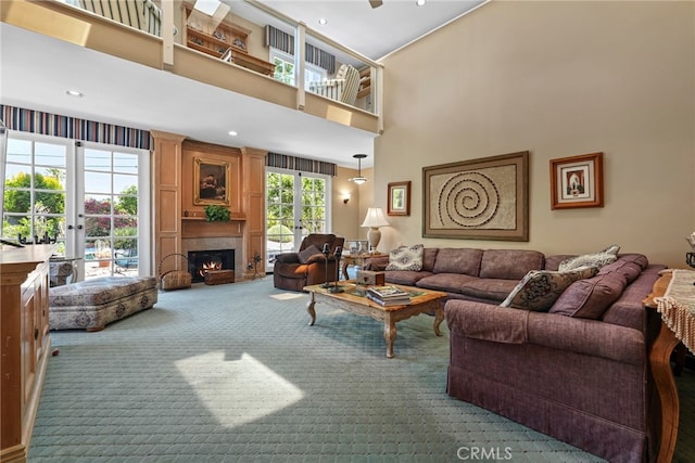 8601 Rudnick Ave, West Hills, CA 91304 - living room featuring carpet, a towering ceiling, a fireplace, and recessed lighting