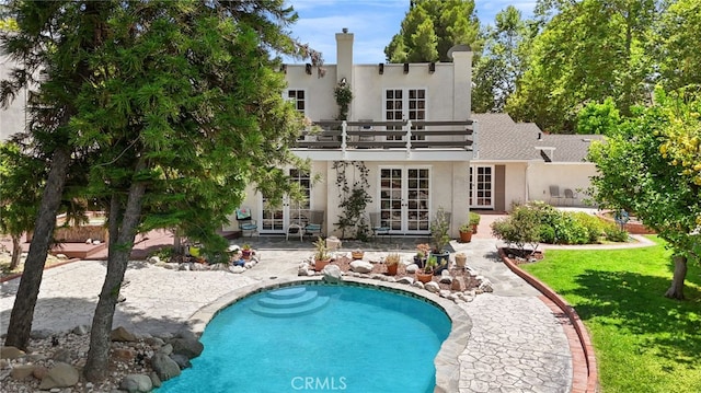 8601 Rudnick Ave, West Hills, CA 91304 - rear view of house with french doors, stucco siding, a balcony, and a patio