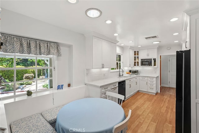 8601 Rudnick Ave, West Hills, CA 91304 - kitchen featuring black appliances, plenty of natural light, white cabinets, and recessed lighting