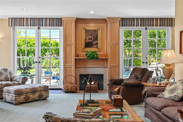 8601 Rudnick Ave, West Hills, CA 91304 - carpeted living room featuring french doors, a glass covered fireplace, and plenty of natural light