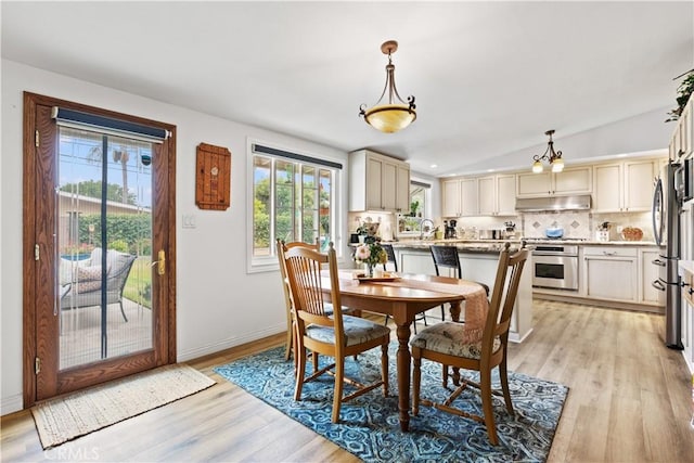 14091 Dall Ln, Tustin, CA 92780 - dining area with light wood finished floors and vaulted ceiling