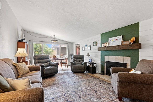 14091 Dall Ln, Tustin, CA 92780 - living room featuring vaulted ceiling, a tile fireplace, a textured ceiling, and wood finished floors