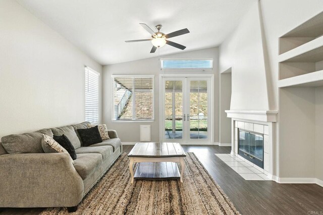 46076 Via Ln, Colorada, Temecula, CA 92592 - living area featuring a ceiling fan, vaulted ceiling, wood finished floors, a fireplace, and french doors