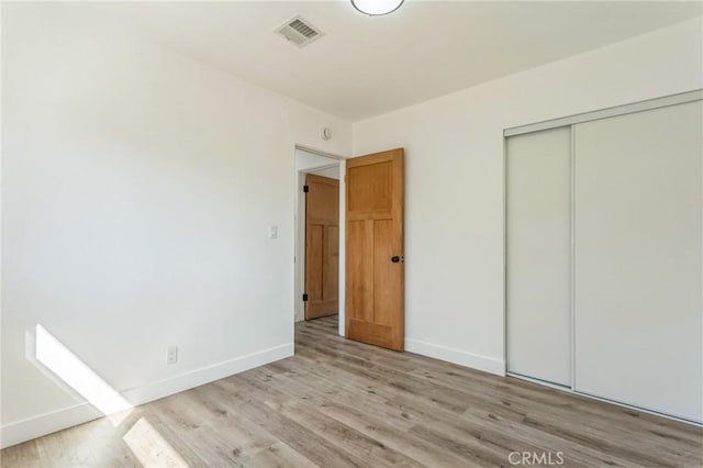 38876 Foxholm Dr, Palmdale, CA 93551 - unfurnished bedroom with light wood-style flooring and a closet