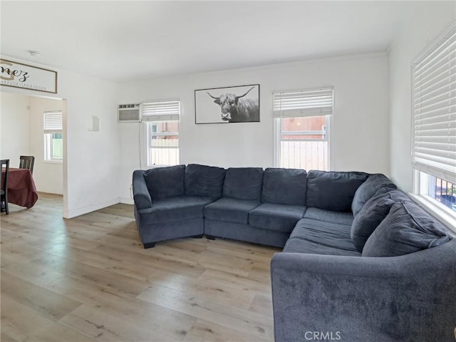 5960 Lime Ave, Long Beach, CA 90805 - living room with light wood finished floors and an AC wall unit