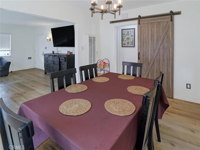 5960 Lime Ave, Long Beach, CA 90805 - dining room featuring light wood-style flooring, a chandelier, and a barn door
