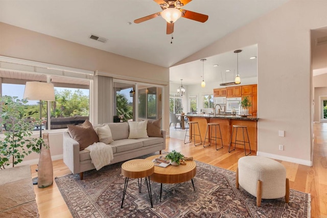 2149 Gamble Pl, Escondido, CA 92029 - living room with light wood-style flooring, ceiling fan, vaulted ceiling, and a chandelier