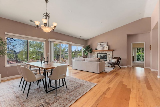 2149 Gamble Pl, Escondido, CA 92029 - dining area with light wood-style flooring, a fireplace, plenty of natural light, and vaulted ceiling