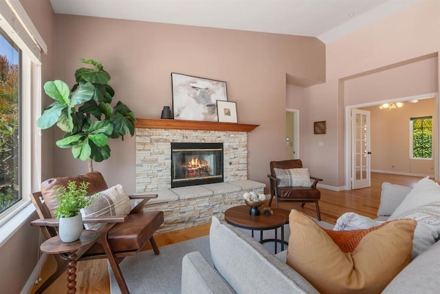 2149 Gamble Pl, Escondido, CA 92029 - living room with wood finished floors, a stone fireplace, and lofted ceiling