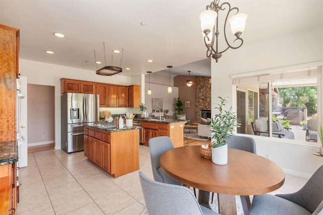 2149 Gamble Pl, Escondido, CA 92029 - kitchen with stainless steel fridge with ice dispenser, brown cabinets, a kitchen island, a peninsula, and a chandelier