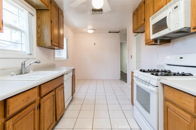 15300 Mayall St, San Fernando, CA 91345 - kitchen featuring white appliances, light countertops, ceiling fan, brown cabinets, and light tile patterned flooring
