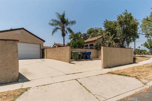 15300 Mayall St, San Fernando, CA 91345 - view of home's exterior featuring concrete driveway and stucco siding