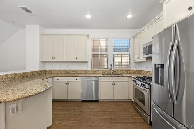 1837 Olive Green St Unit 3, Chula Vista, CA 91913 - kitchen featuring appliances with stainless steel finishes, dark wood-style flooring, recessed lighting, light stone counters, and white cabinets