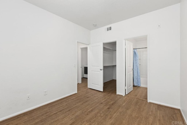 1837 Olive Green St Unit 3, Chula Vista, CA 91913 - unfurnished bedroom featuring wood finished floors, a walk in closet, a closet, and connected bathroom