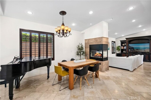 289 23rd St, Costa Mesa, CA 92627 - dining room with a chandelier, recessed lighting, lofted ceiling, a multi sided fireplace, and light stone finish flooring