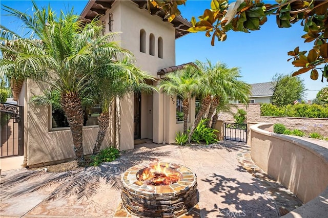 289 23rd St, Costa Mesa, CA 92627 - view of patio featuring a gate and a fire pit