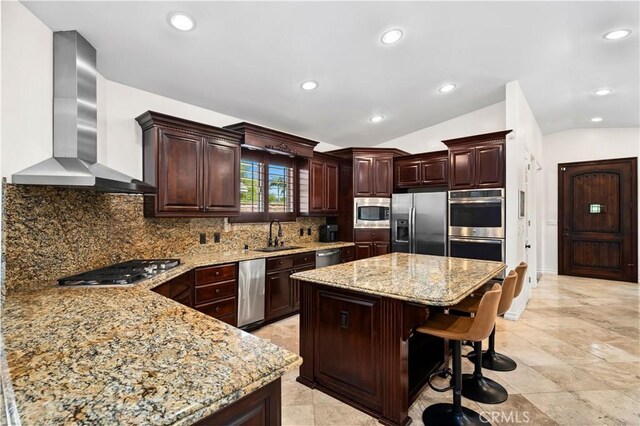 289 23rd St, Costa Mesa, CA 92627 - kitchen with wall chimney exhaust hood, stainless steel appliances, vaulted ceiling, light stone counters, and a kitchen island