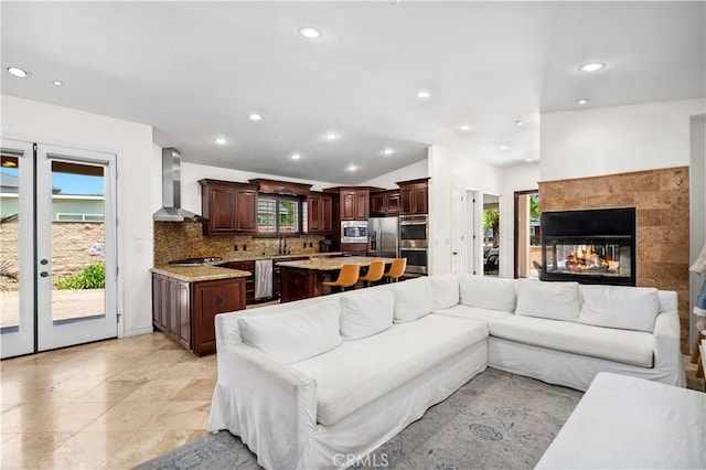289 23rd St, Costa Mesa, CA 92627 - living room featuring french doors, recessed lighting, a tiled fireplace, and lofted ceiling