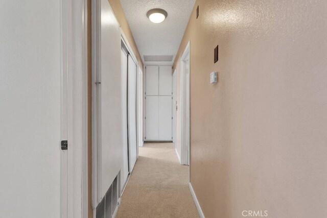 10723 Portland Ave, Hesperia, CA 92345 - hall featuring light colored carpet and a textured ceiling