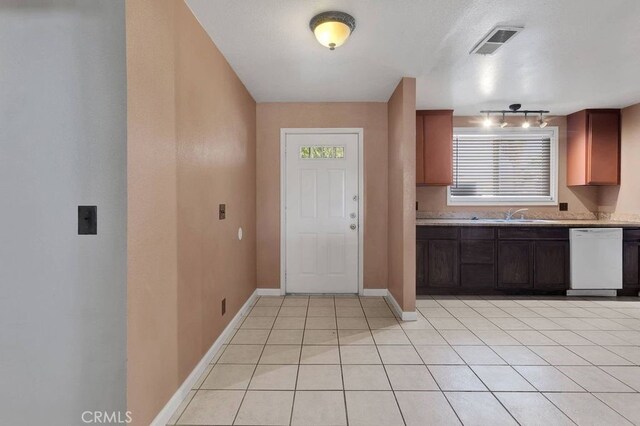 10723 Portland Ave, Hesperia, CA 92345 - kitchen with white dishwasher, light tile patterned floors, rail lighting, and light countertops