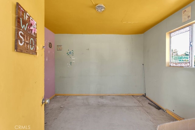 10723 Portland Ave, Hesperia, CA 92345 - empty room featuring concrete floors and baseboards