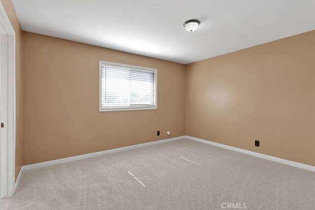 10723 Portland Ave, Hesperia, CA 92345 - unfurnished room with light colored carpet