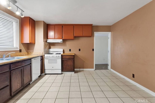 10723 Portland Ave, Hesperia, CA 92345 - kitchen with white appliances, under cabinet range hood, and light countertops