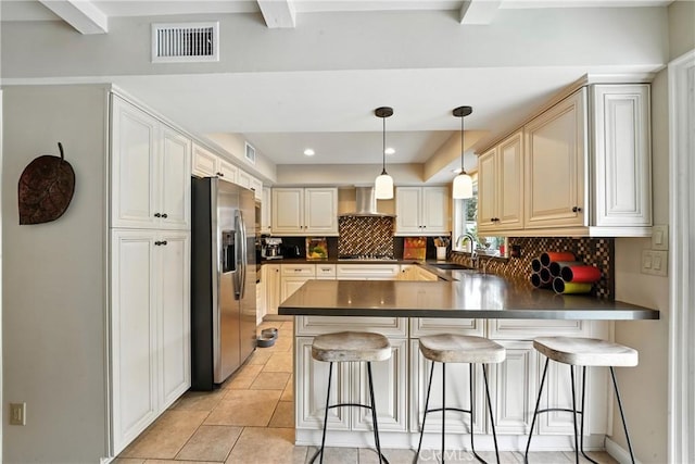 11832 Weatherby Rd, Los Alamitos, CA 90720 - kitchen with stainless steel appliances, dark countertops, a peninsula, decorative backsplash, and wall chimney range hood