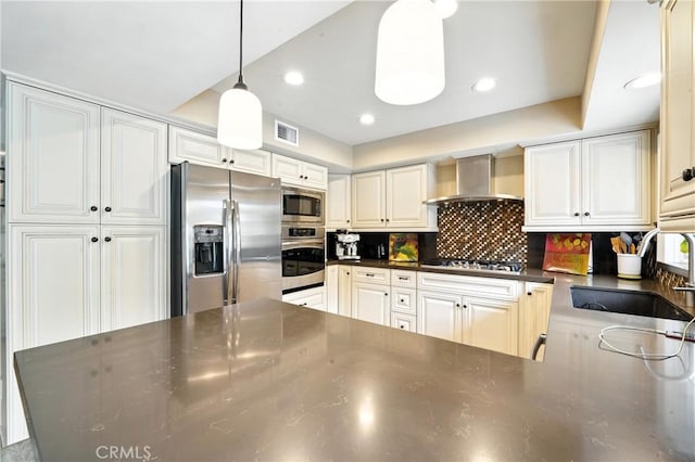 11832 Weatherby Rd, Los Alamitos, CA 90720 - kitchen with appliances with stainless steel finishes, wall chimney exhaust hood, dark countertops, tasteful backsplash, and pendant lighting