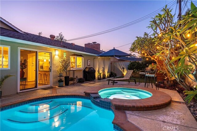 11832 Weatherby Rd, Los Alamitos, CA 90720 - pool at dusk with a patio, area for grilling, and a pool with connected hot tub