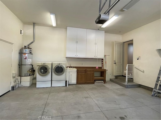 2068 Radnor Ave, Long Beach, CA 90815 - laundry area featuring cabinet space, washing machine and dryer, strapped water heater, and a garage