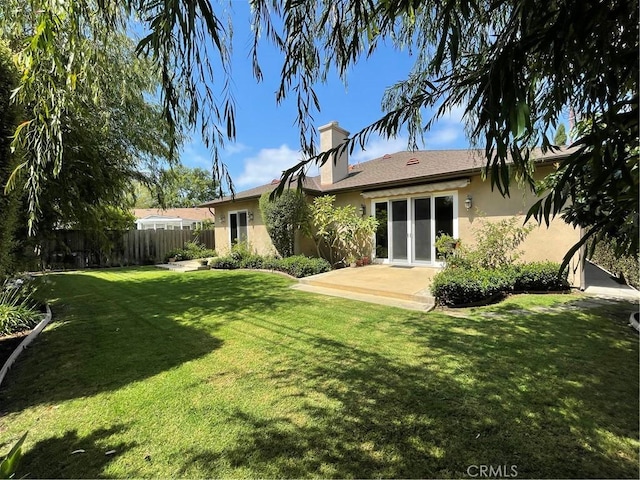 2068 Radnor Ave, Long Beach, CA 90815 - rear view of house featuring stucco siding, a patio, and a chimney