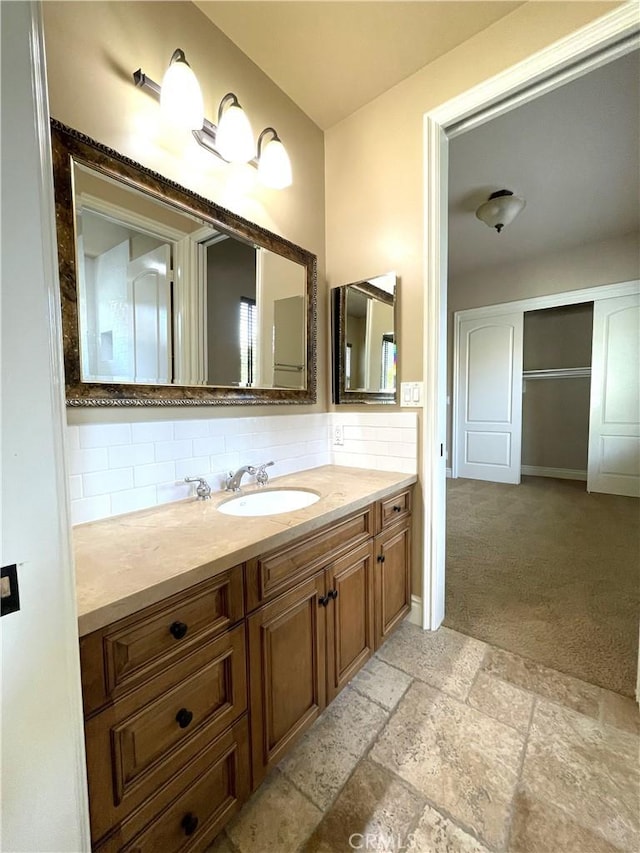 2068 Radnor Ave, Long Beach, CA 90815 - bathroom featuring vanity, tasteful backsplash, and stone tile floors