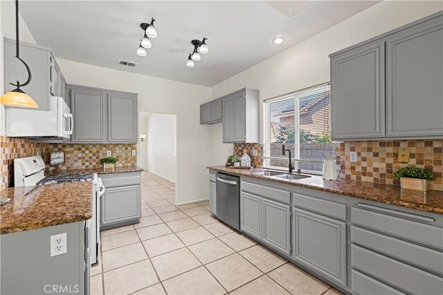 42158 Valley Vista Dr, Lancaster, CA 93536 - kitchen with white appliances, gray cabinets, light tile patterned floors, and tasteful backsplash