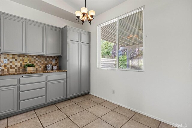 42158 Valley Vista Dr, Lancaster, CA 93536 - bar with a chandelier, backsplash, light tile patterned floors, and hanging light fixtures