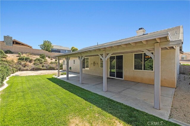 42158 Valley Vista Dr, Lancaster, CA 93536 - back of house featuring stucco siding, a yard, a chimney, and a patio area