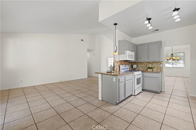 42158 Valley Vista Dr, Lancaster, CA 93536 - kitchen featuring white appliances, gray cabinets, vaulted ceiling, tasteful backsplash, and light tile patterned flooring