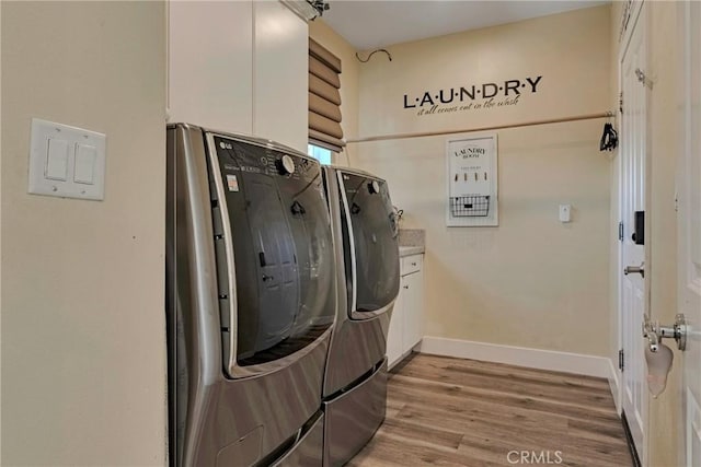 19639 Ellis Henry Ct, Newhall, CA 91321 - laundry area with separate washer and dryer, light wood-type flooring, and cabinet space
