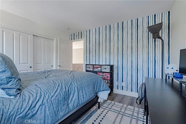 19639 Ellis Henry Ct, Newhall, CA 91321 - bedroom with wallpapered walls, wood finished floors, and a closet