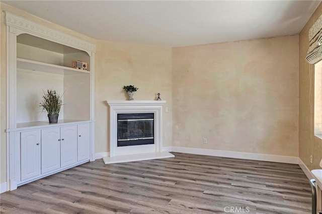 19639 Ellis Henry Ct, Newhall, CA 91321 - unfurnished living room with wood finished floors and a glass covered fireplace
